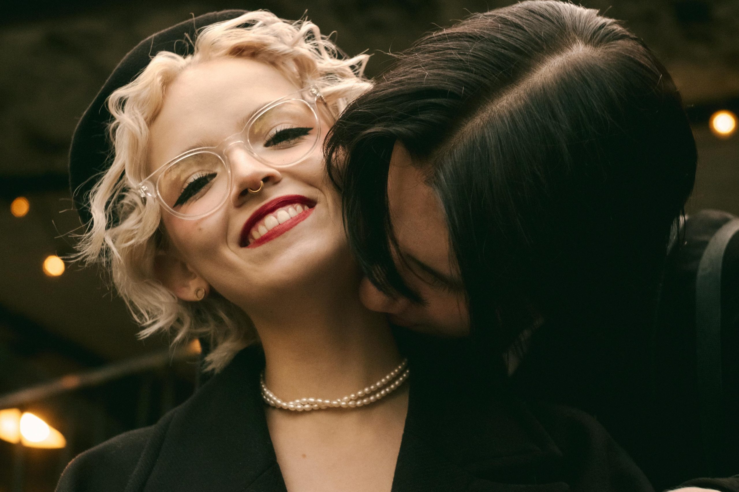 A joyful couple shares a loving embrace outdoors, highlighting happiness and affection.